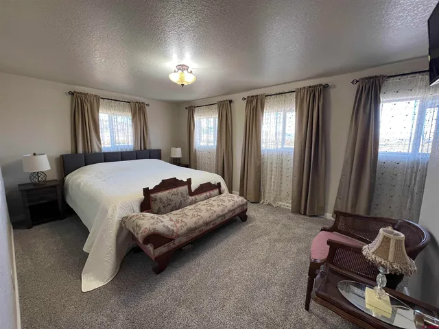 a bedroom with a bed lamp and a window