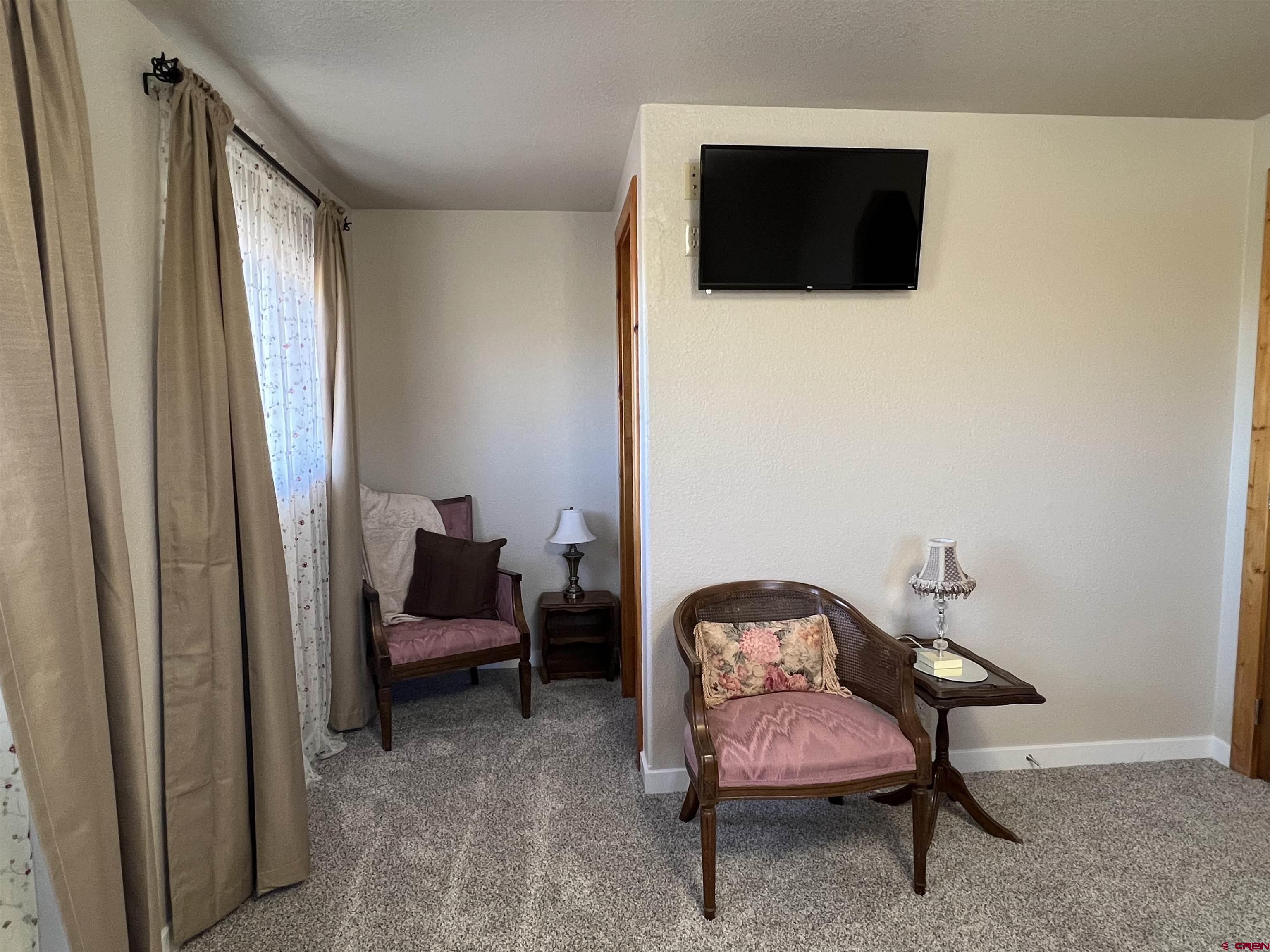 41400 Co Road Saguache, CO 81149 - Photo 22 of 45 a bedroom with a chair and a window