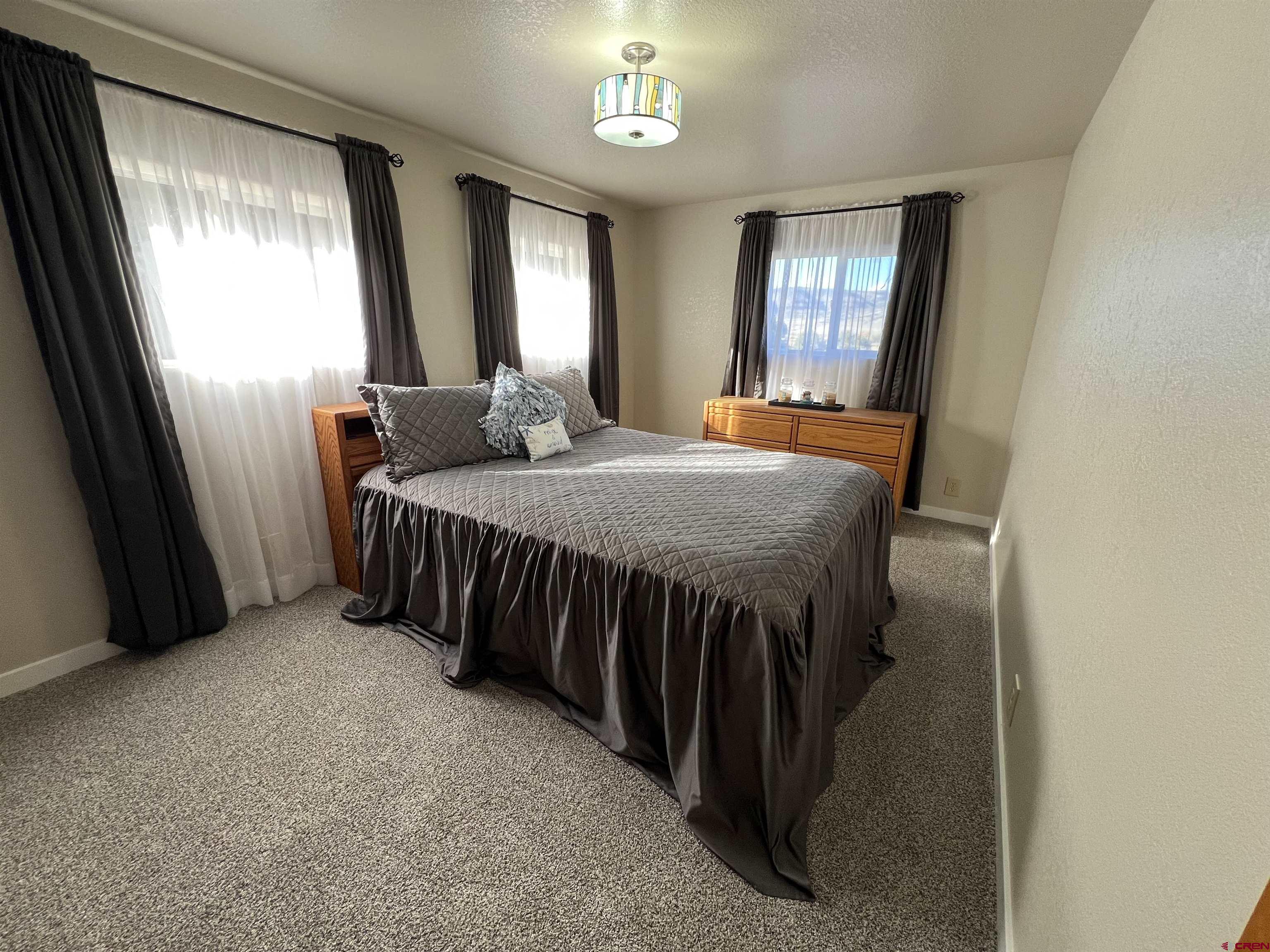 41400 Co Road Saguache, CO 81149 - Photo 25 of 45 a bed sitting in a bedroom next to a window