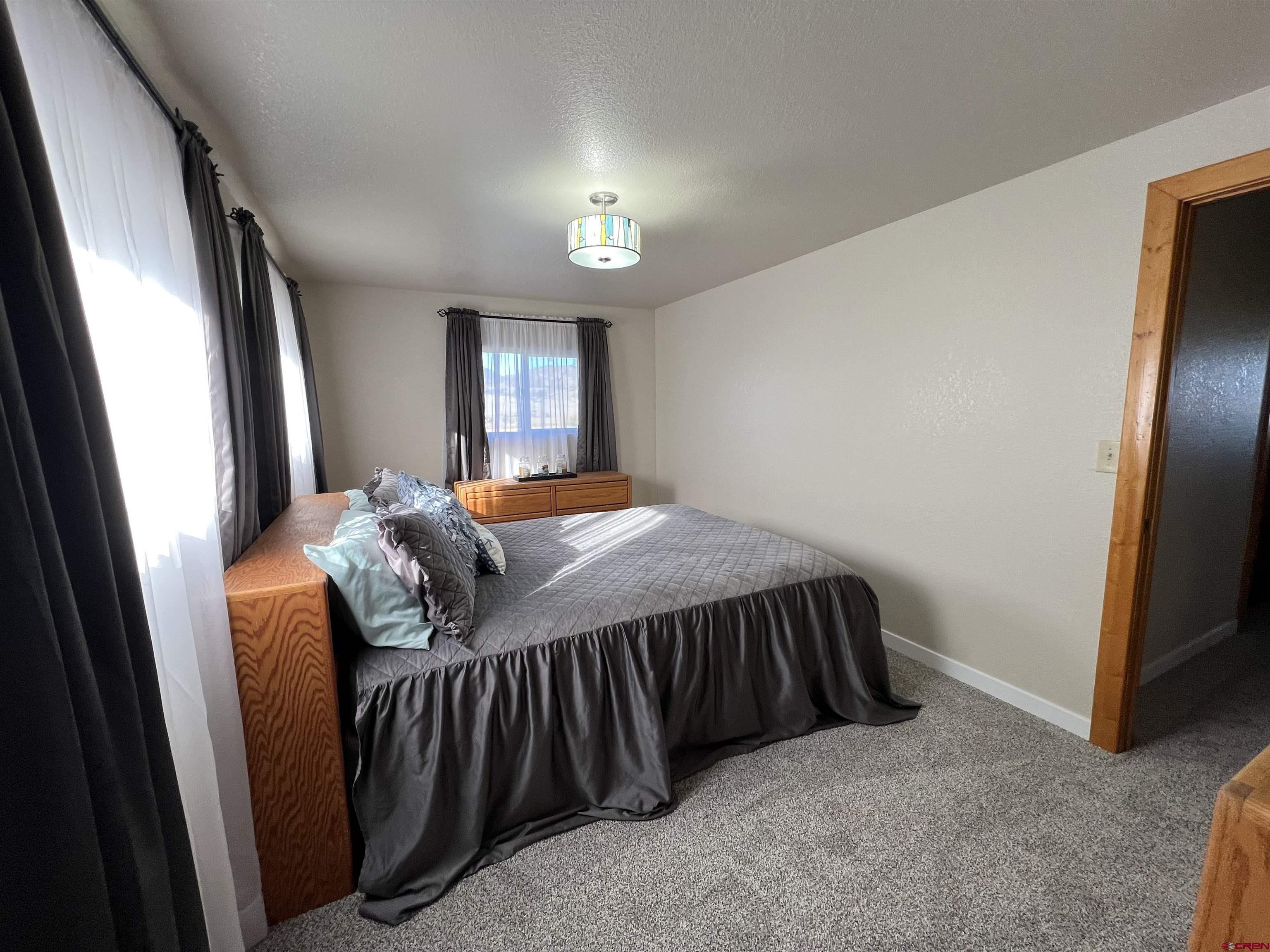 41400 Co Road Saguache, CO 81149 - Photo 26 of 45 a bed sitting in a bedroom next to a window