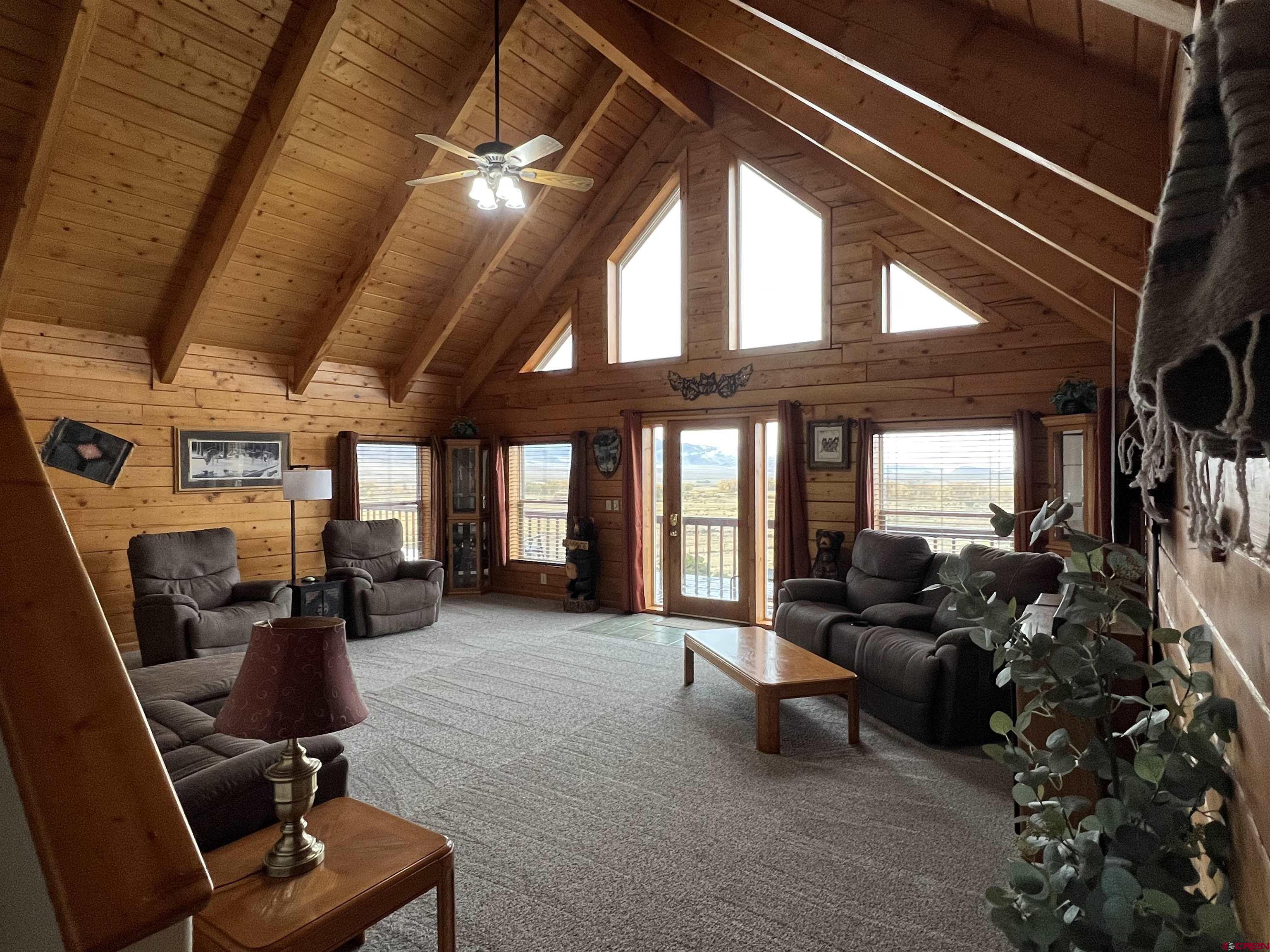 41400 Co Road Saguache, CO 81149 - Photo 3 of 45 a living room with furniture gym equipment and large windows