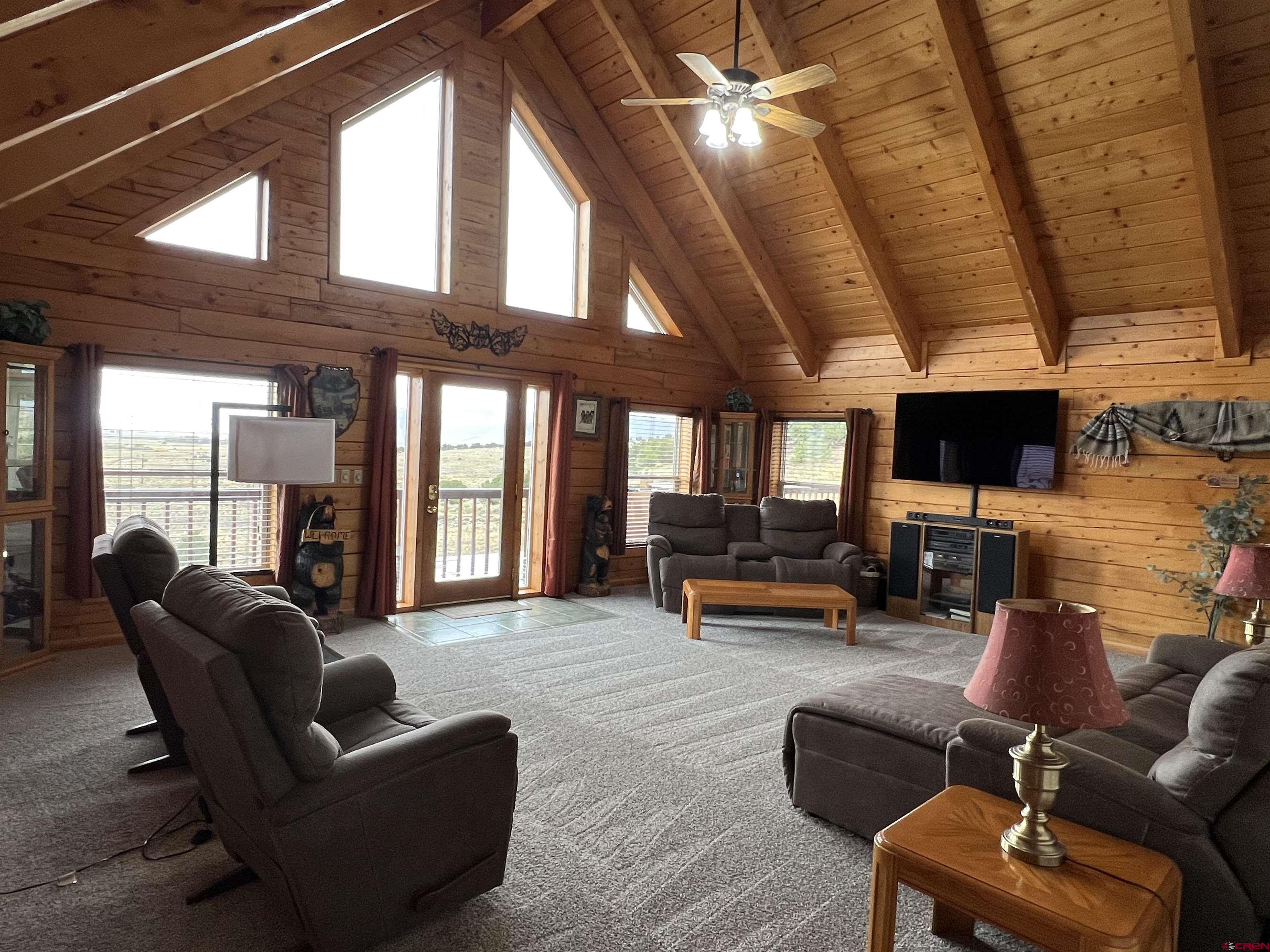 41400 Co Road Saguache, CO 81149 - Photo 3 of 45 a living room with furniture and a flat screen tv