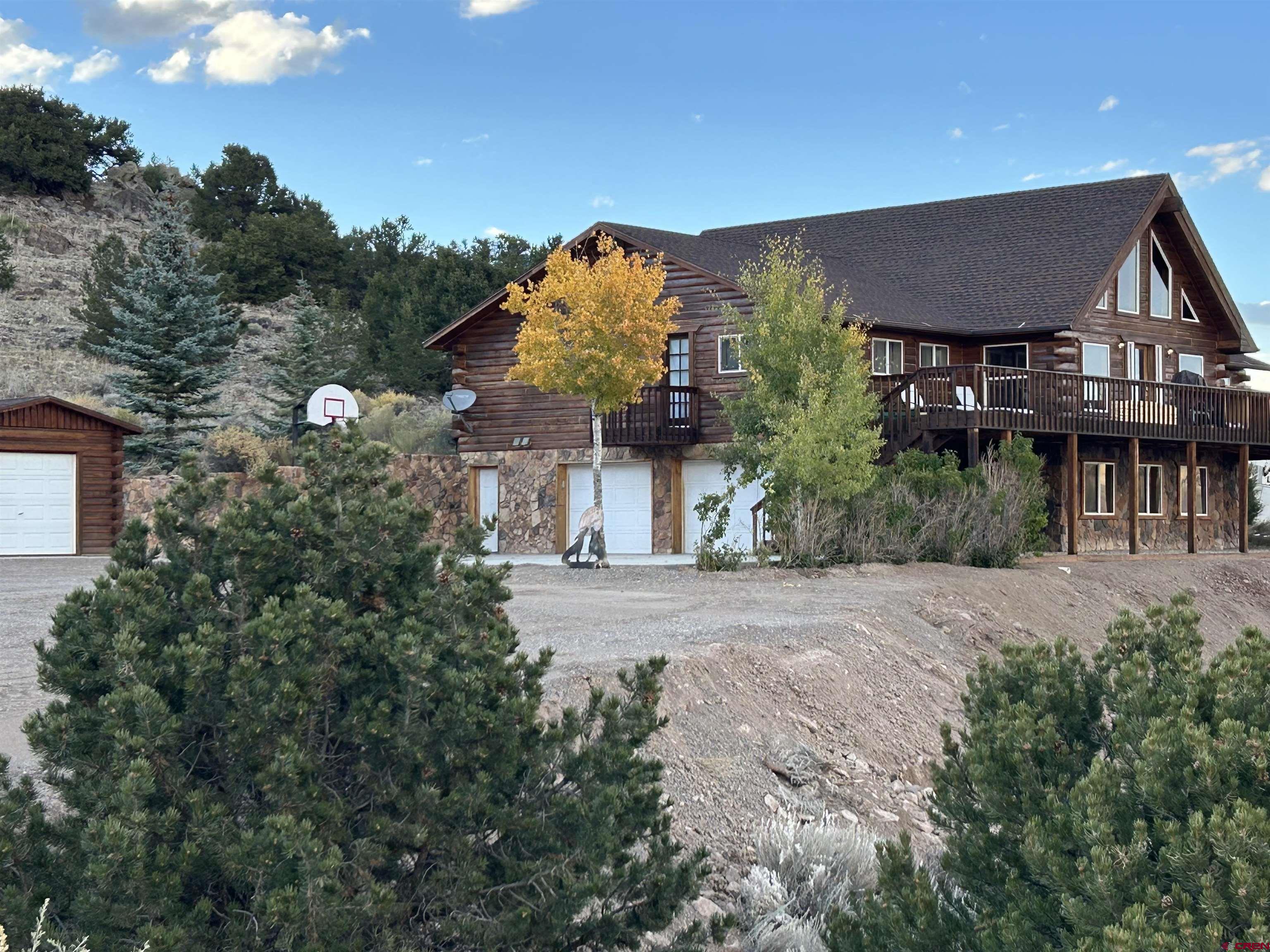 41400 Co Road Saguache, CO 81149 - Photo 34 of 45 a front view of a house with a yard and garage