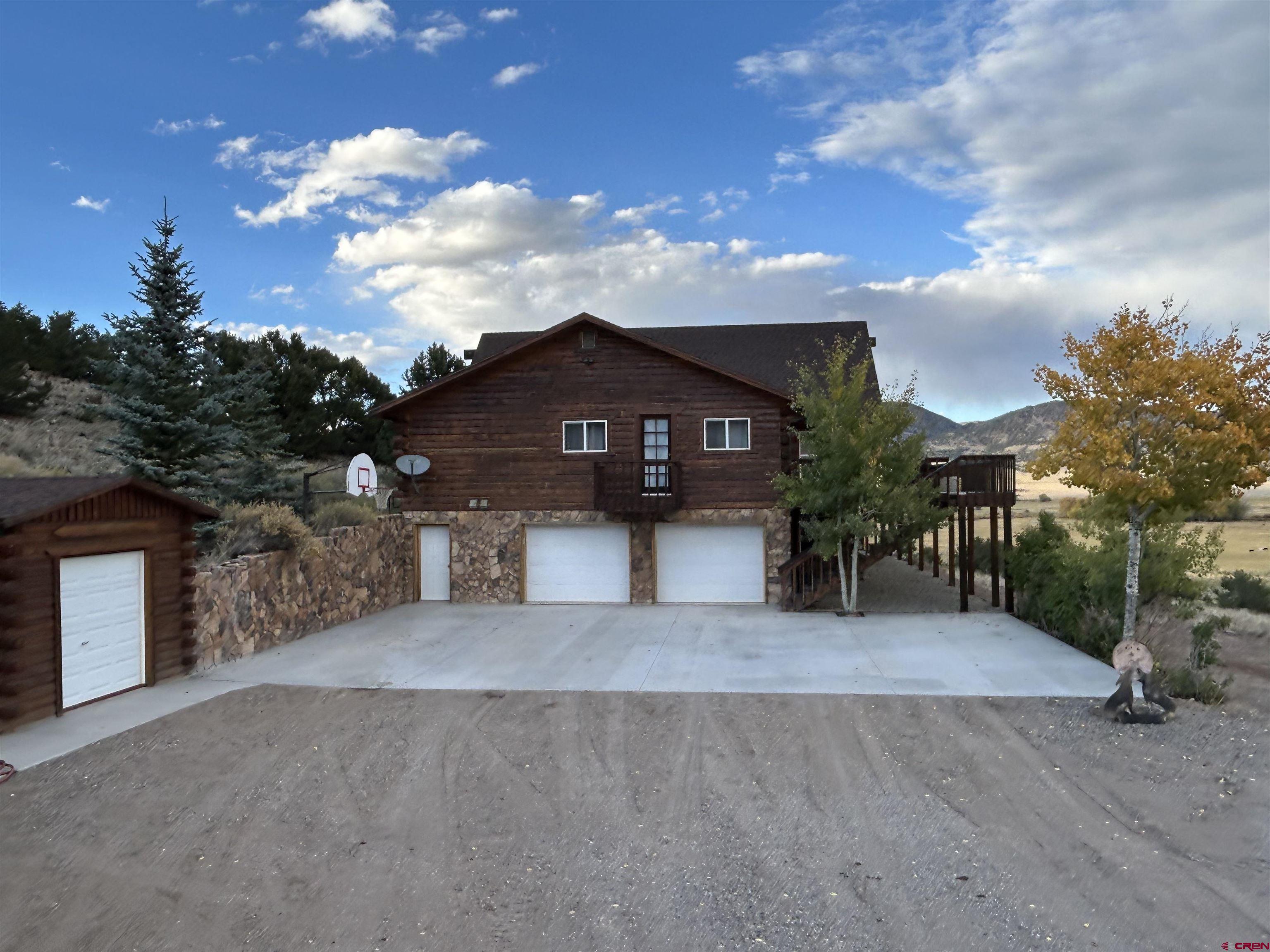 41400 Co Road Saguache, CO 81149 - Photo 35 of 45 a view of a house with a yard and potted plants