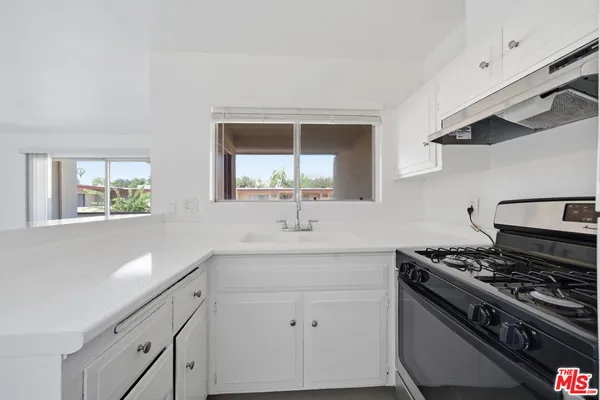 a kitchen with a stove and a sink