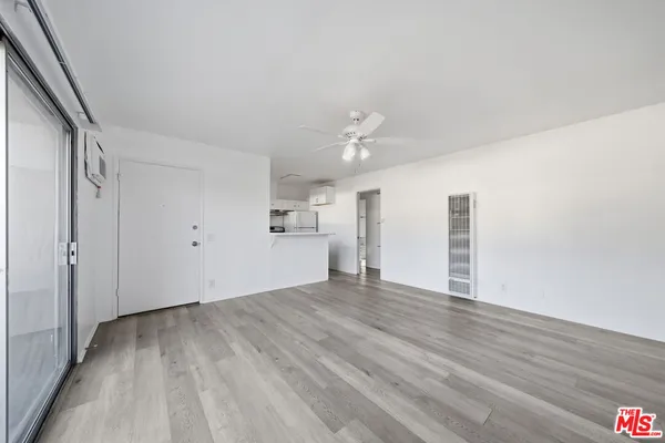 a view of empty room with wooden floor