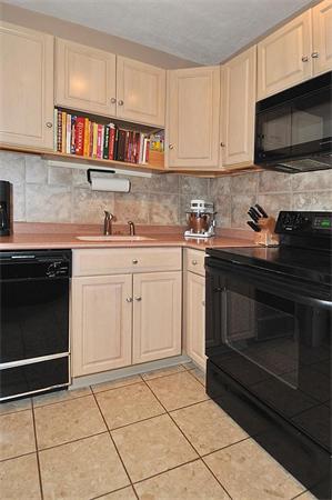 65 Strathmore Road, Unit 7 169 900 Boston, MA 02135 - Photo 5 of 17 a kitchen with cabinets stainless steel appliances and a sink