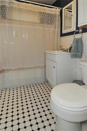 65 Strathmore Road, Unit 7 169 900 Boston, MA 02135 - Photo 8 of 17 a bathroom with a sink toilet and mirror