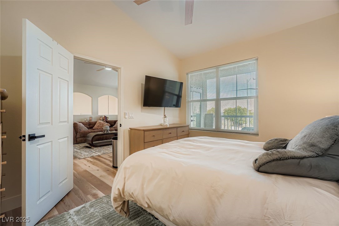 10001 Peace Way, Unit 2352 Las Vegas, NV 89147 - Photo 12 of 24 Bedroom with vaulted ceiling, light wood-style flooring, ceiling fan, and arched walkways