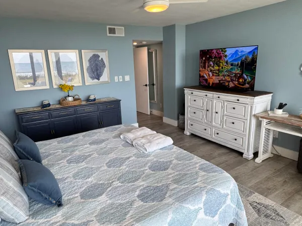 a bedroom with a bed window and dresser