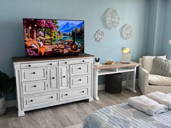 a bedroom with a bed and a dresser