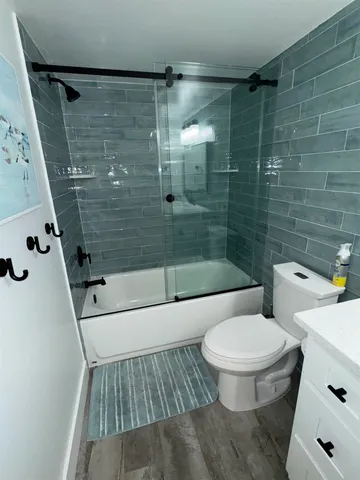a bathroom with a toilet and a shower