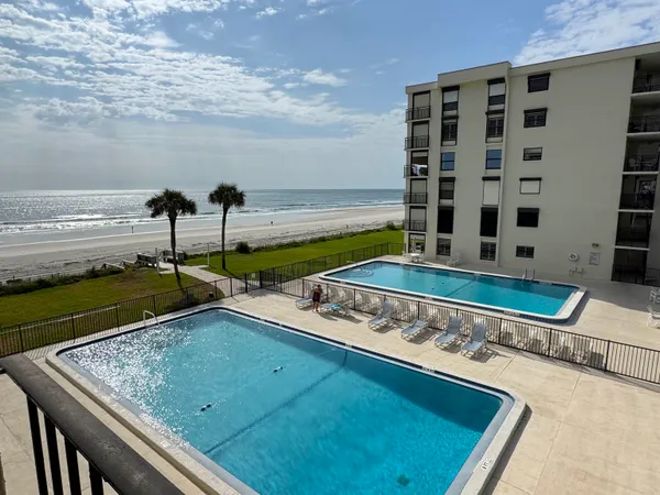a view of a swimming pool with outdoor seating