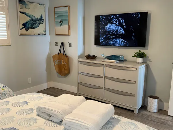 a bedroom with a bed and a painting on the wall