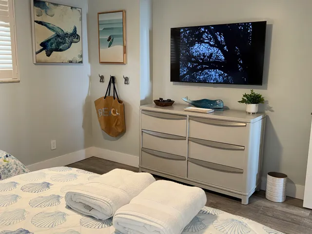 a bedroom with a bed and a painting on the wall