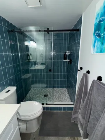 a bathroom with a toilet and a shower