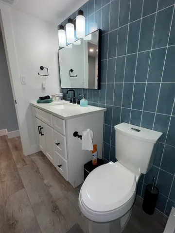 a bathroom with a toilet a sink and mirror
