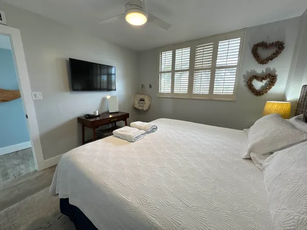 a bedroom with a bed and window