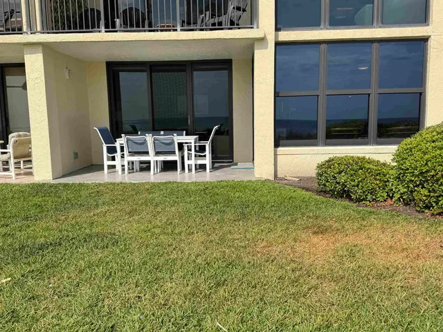 a couple of table and chair in front of a house