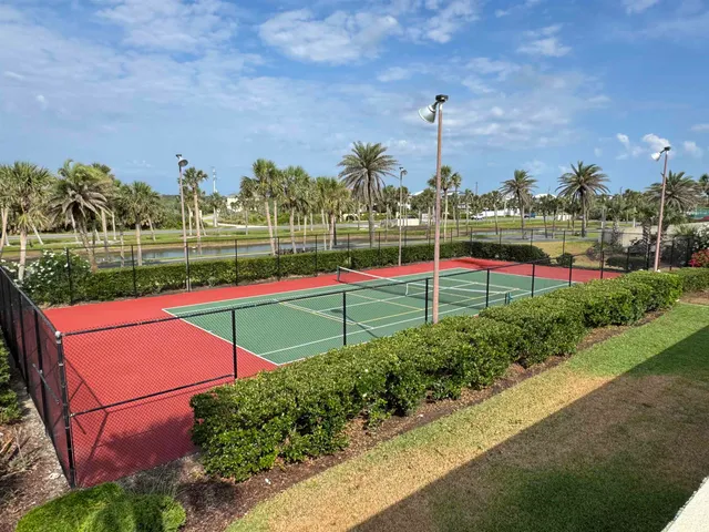 a view of a park with large trees and a small yard