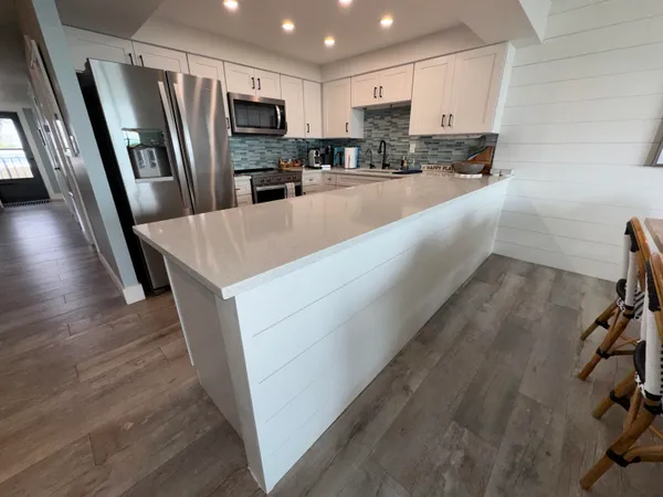 a kitchen with stainless steel appliances a refrigerator and a sink