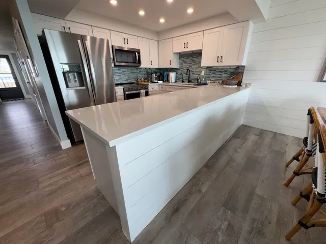a kitchen with stainless steel appliances a refrigerator and a sink