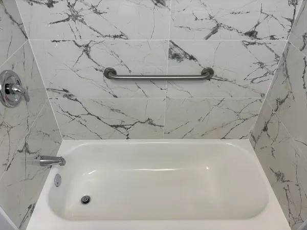 a view of a house with a wooden fence