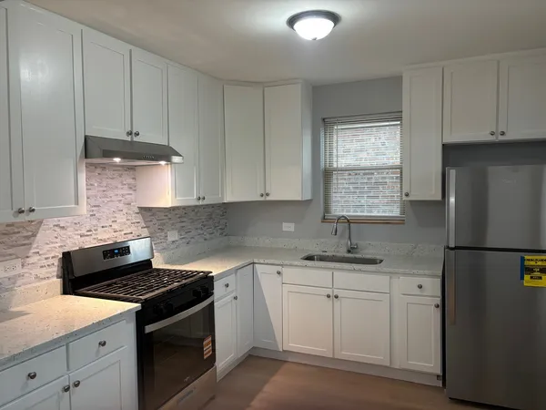 a stove top oven sitting inside of a kitchen