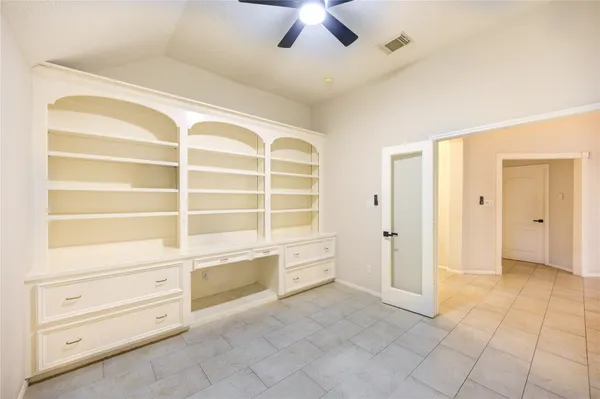 an empty room with a window and wooden floor