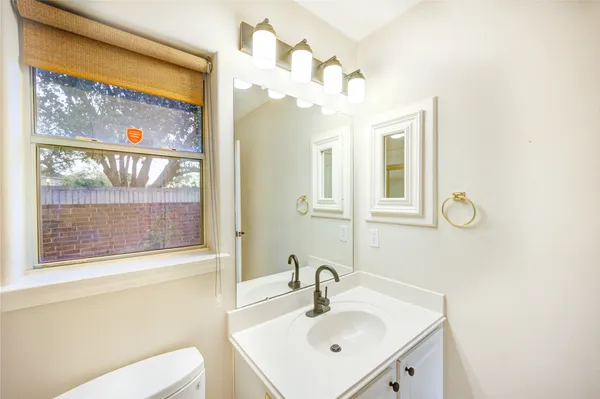a view of a big room with wooden floor and windows