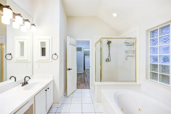 a bathroom with a sink double vanity and a mirror