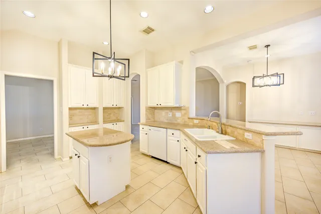 a bathroom with a granite countertop sink a mirror and a bathtub
