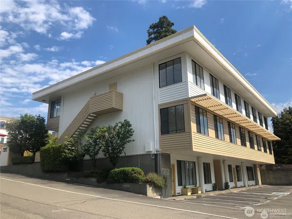 a front view of a house with plants