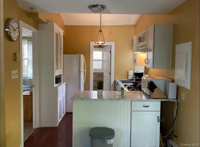 a kitchen with a refrigerator and a sink