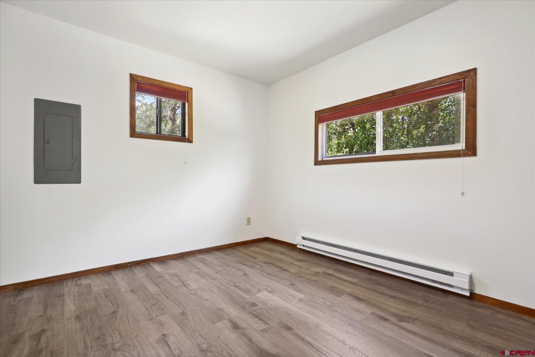 1039 Silver Mesa Driveway Durango, CO 81301 - Photo 14 of 35 a view of an empty room with wooden floor and a window