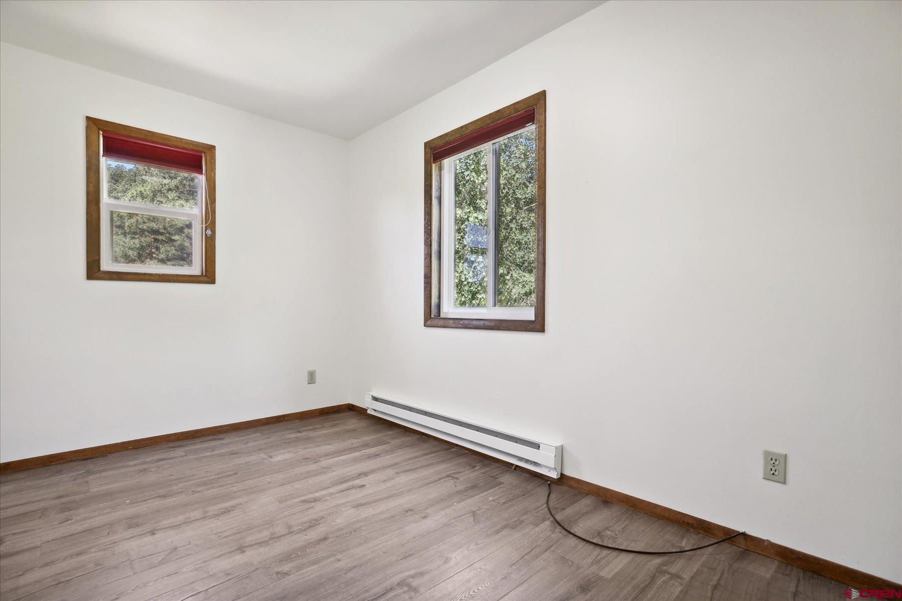 1039 Silver Mesa Driveway Durango, CO 81301 - Photo 15 of 35 an empty room with a wooden floor and a window