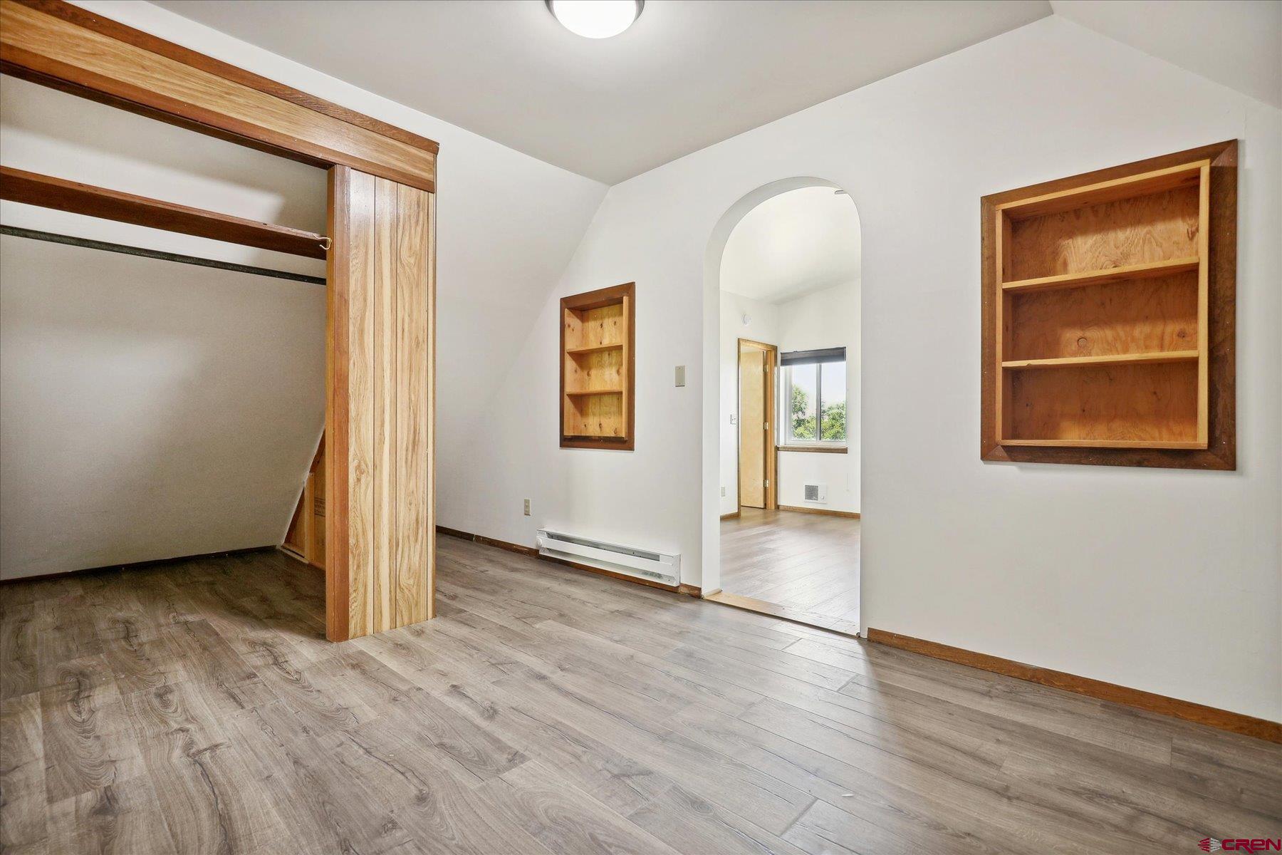 1039 Silver Mesa Driveway Durango, CO 81301 - Photo 16 of 35 an empty room with wooden floor and windows