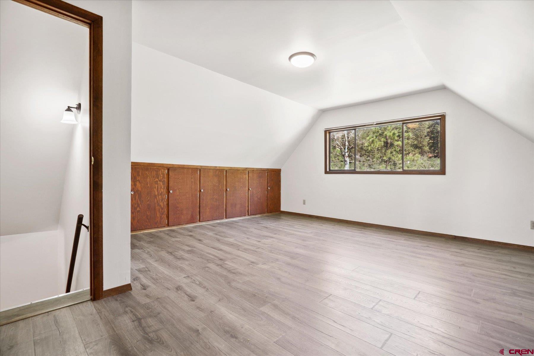 1039 Silver Mesa Driveway Durango, CO 81301 - Photo 17 of 35 an empty room with wooden floor and windows