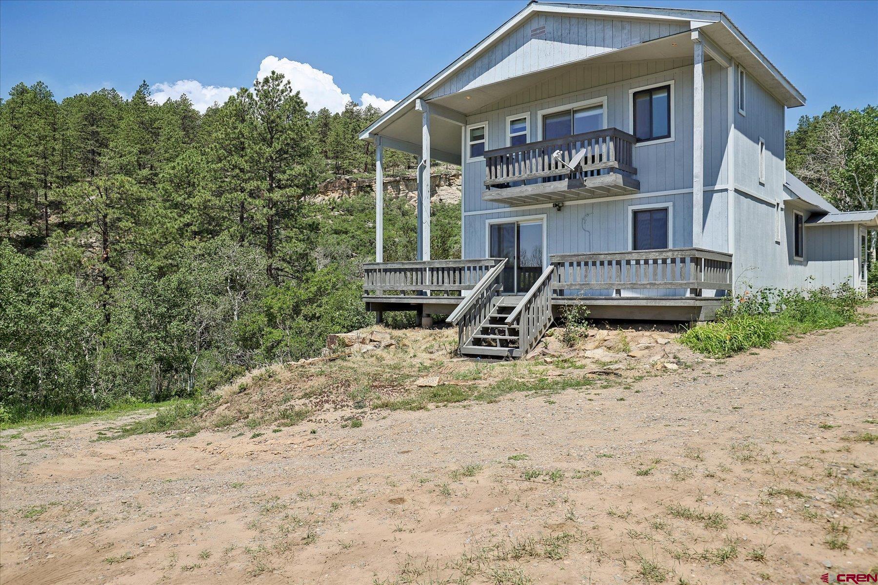 1039 Silver Mesa Driveway Durango, CO 81301 - Photo 22 of 35 a front view of a house with a yard