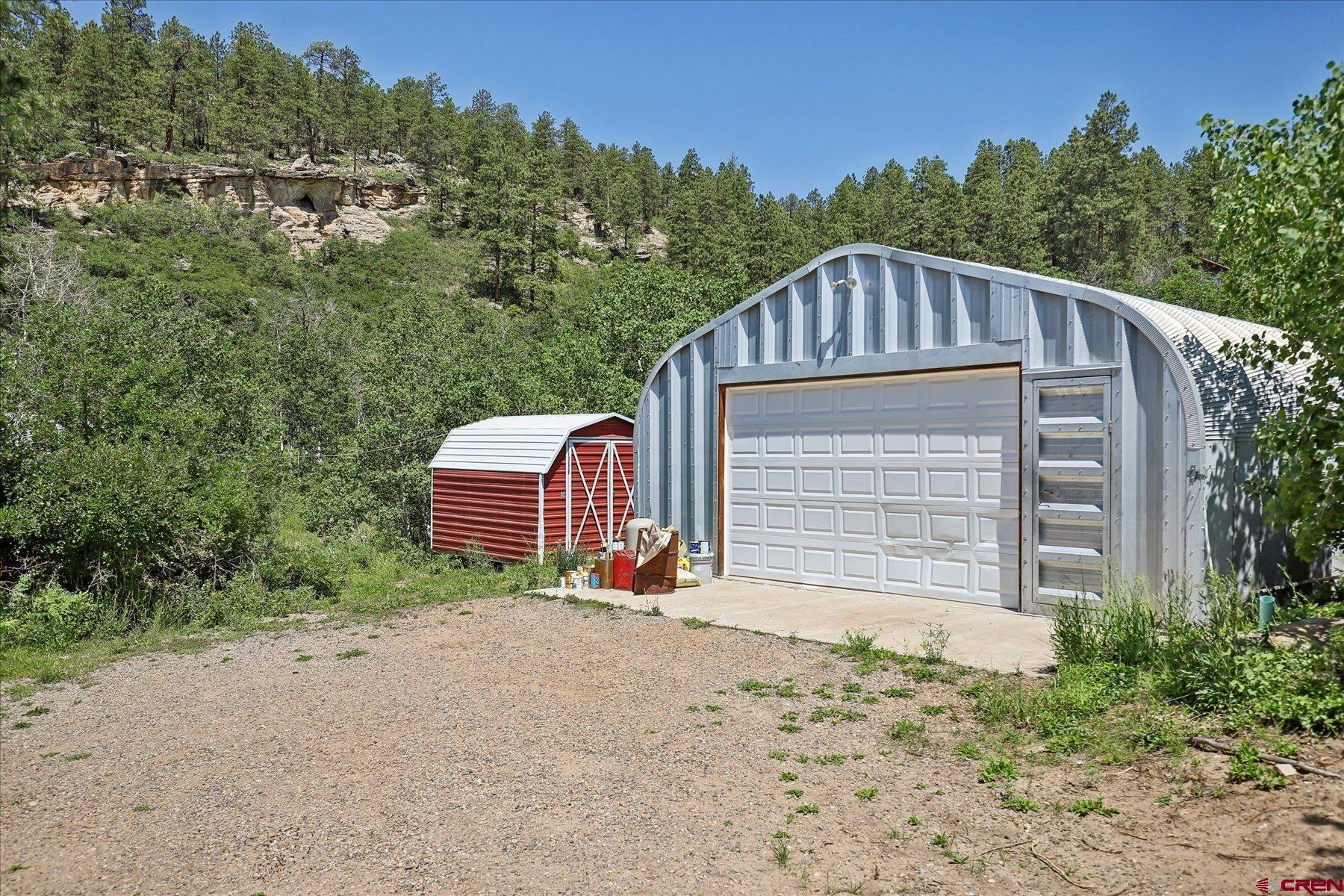 1039 Silver Mesa Driveway Durango, CO 81301 - Photo 24 of 35 a front view of a house with a yard and garage