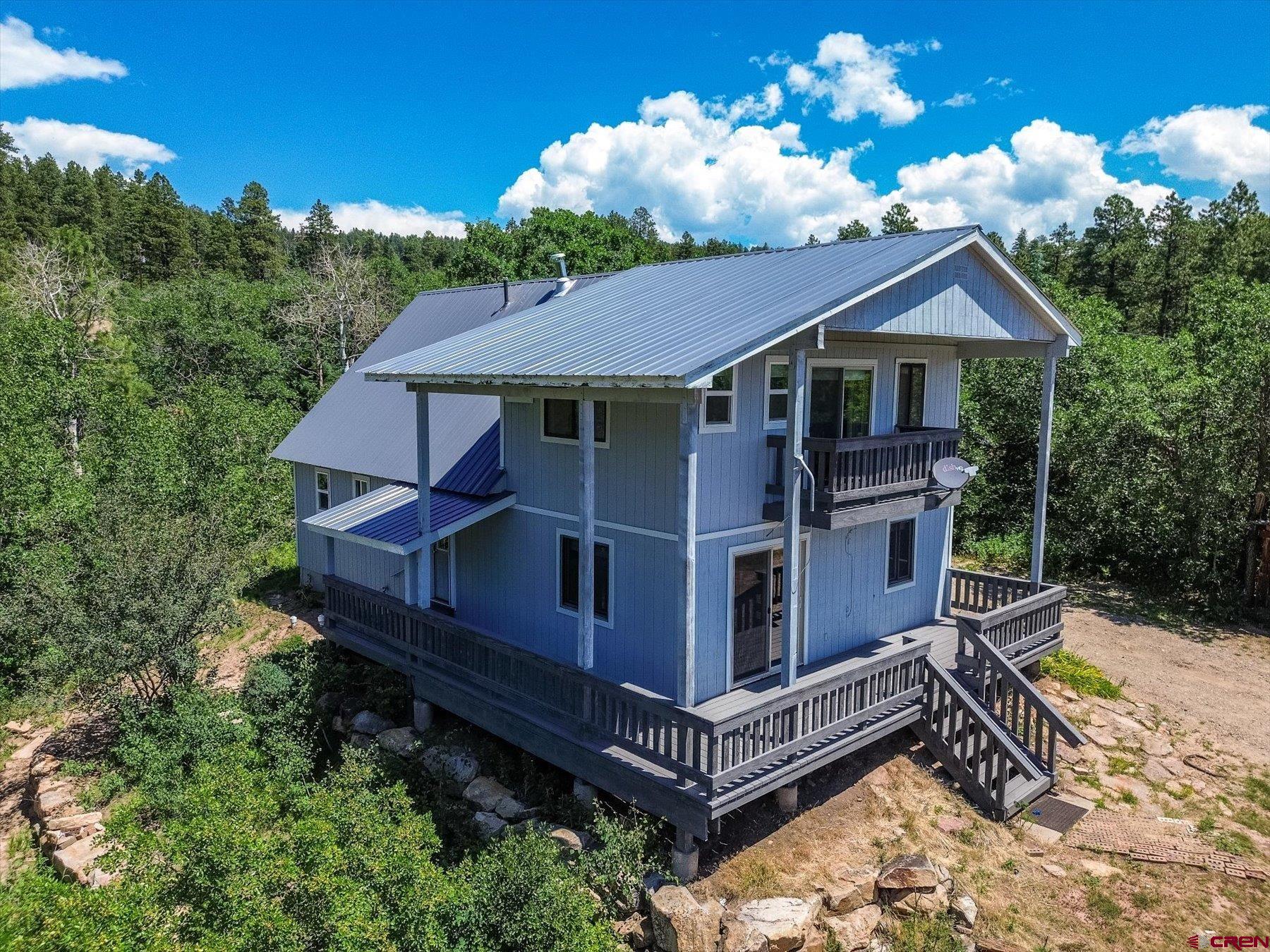 1039 Silver Mesa Driveway Durango, CO 81301 - Photo 30 of 35 a house with trees in the background