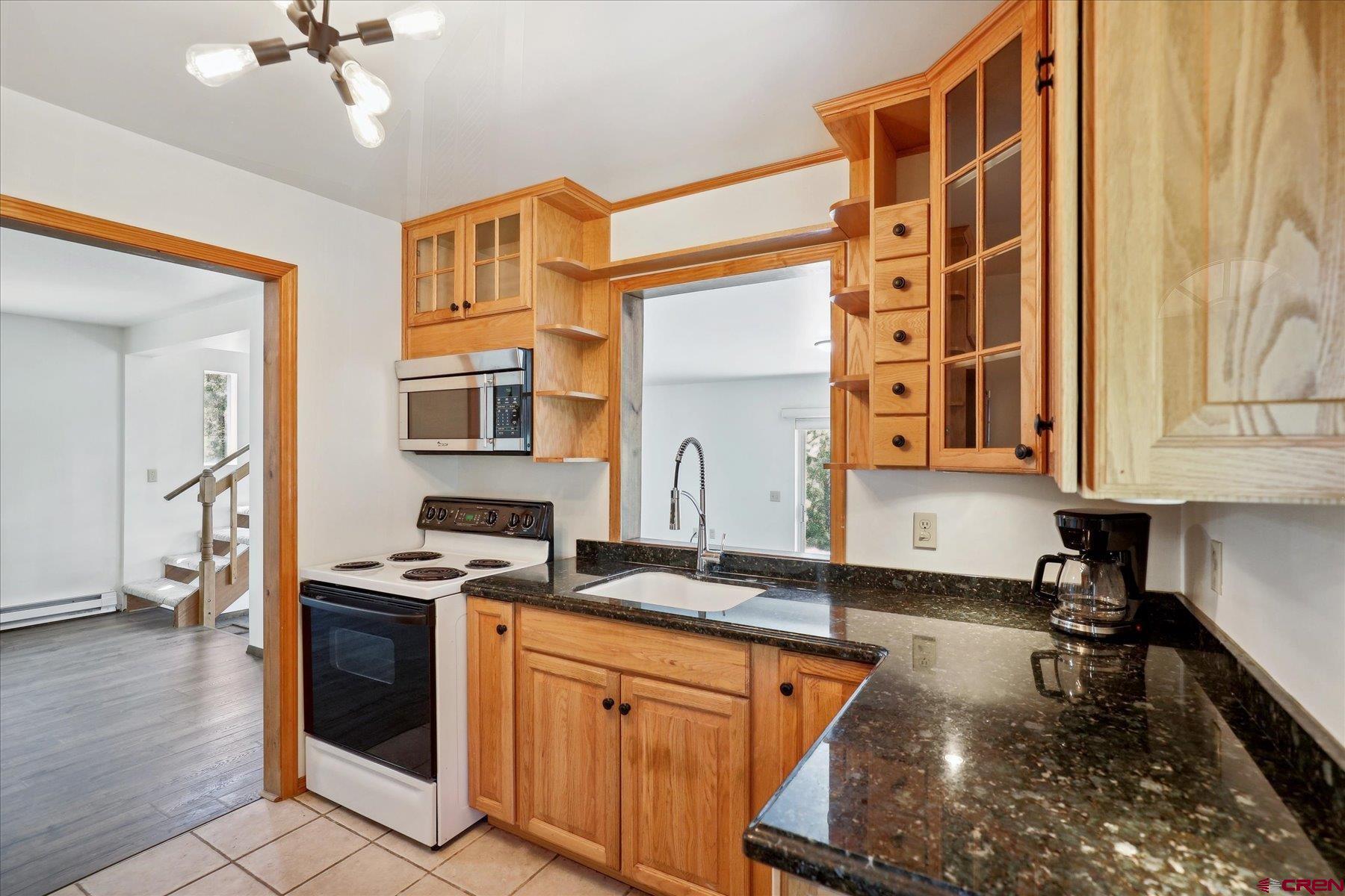1039 Silver Mesa Driveway Durango, CO 81301 - Photo 31 of 35 a kitchen with stainless steel appliances granite countertop a stove a sink and a refrigerator