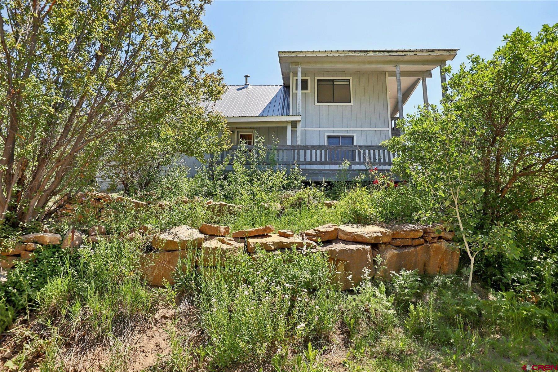 1039 Silver Mesa Driveway Durango, CO 81301 - Photo 34 of 35 a aerial view of a house with a yard and fountain