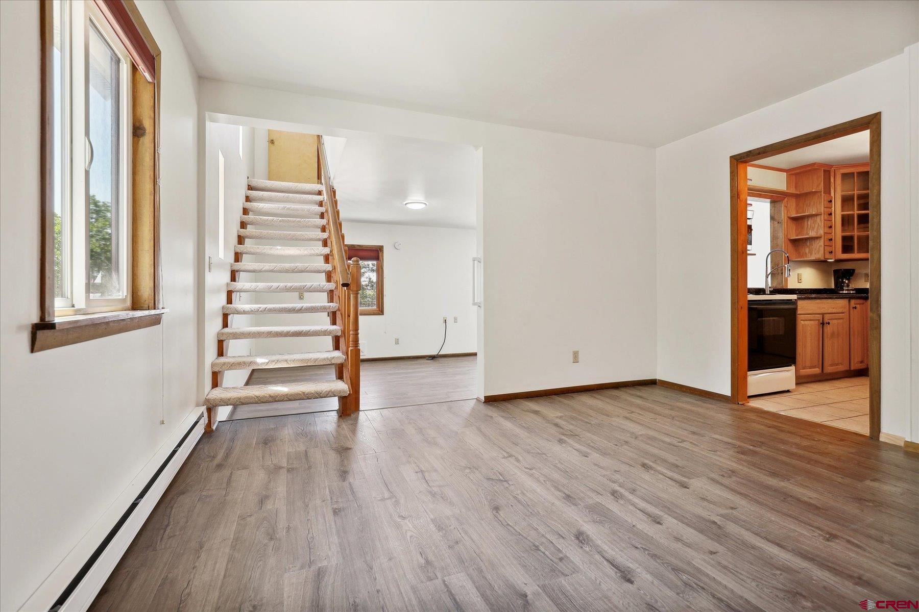1039 Silver Mesa Driveway Durango, CO 81301 - Photo 4 of 35 wooden floor in an empty room with a window