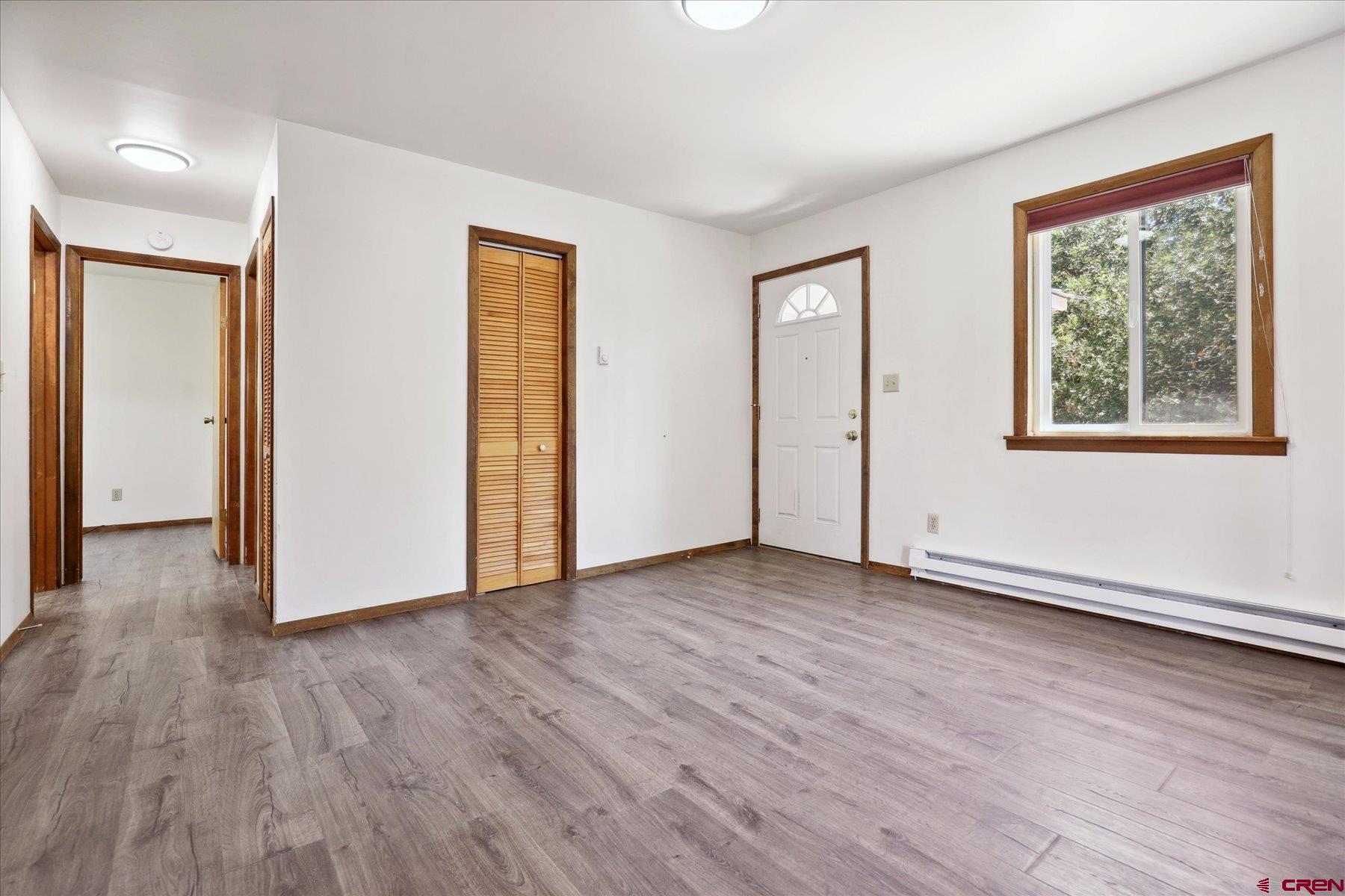 1039 Silver Mesa Driveway Durango, CO 81301 - Photo 5 of 35 an empty room with wooden floor and windows