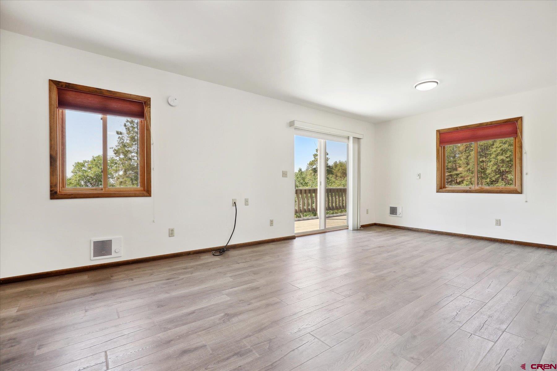 1039 Silver Mesa Driveway Durango, CO 81301 - Photo 6 of 35 a view of an empty room with wooden floor and a window
