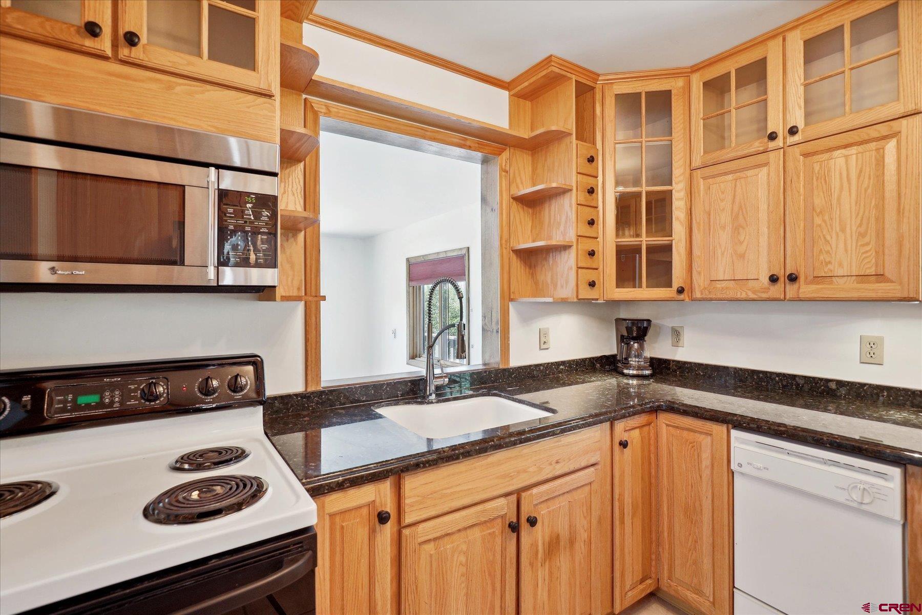 1039 Silver Mesa Driveway Durango, CO 81301 - Photo 7 of 35 a kitchen with stainless steel appliances granite countertop a sink a stove and cabinets