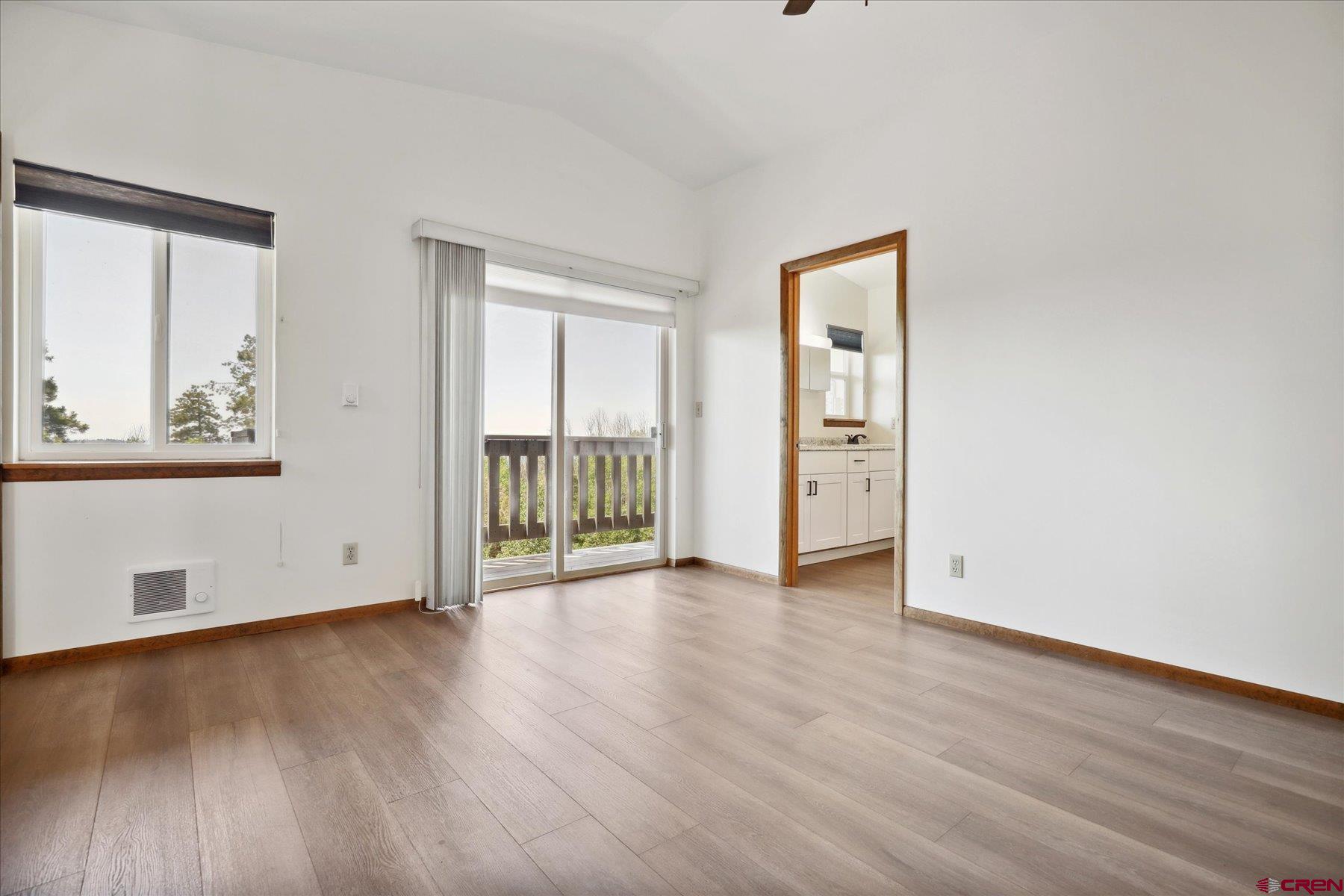 1039 Silver Mesa Driveway Durango, CO 81301 - Photo 9 of 35 a view of an empty room with wooden floor and a window
