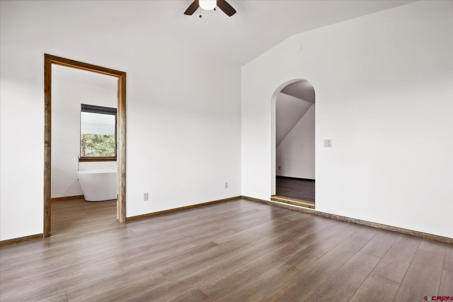 1039 Silver Mesa Driveway Durango, CO 81301 - Photo 10 of 35 a view of an empty room with a window and wooden floor