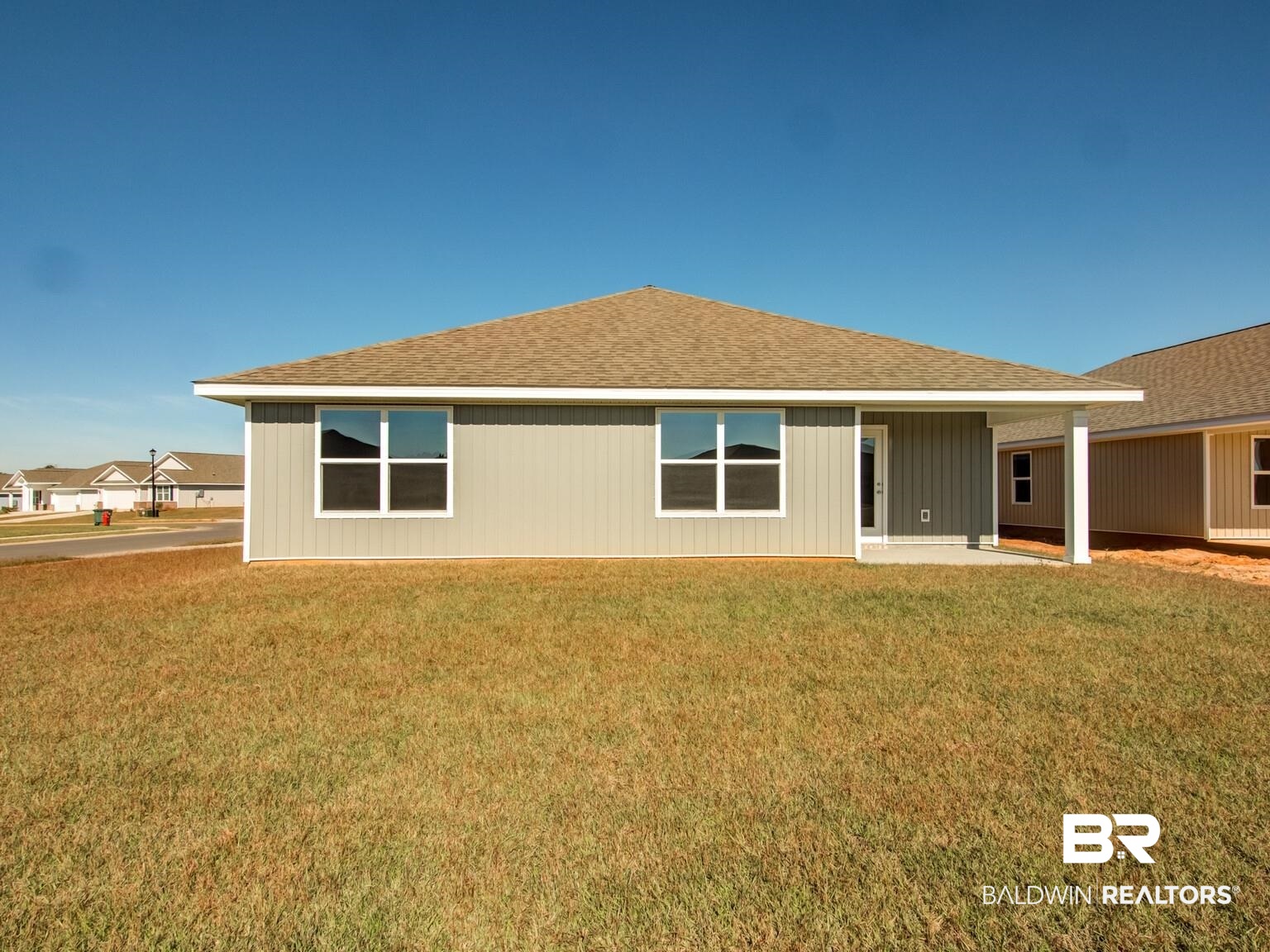 23953 Citation Loop Daphne, AL 36526 - Photo 32 of 49 Back of house featuring a shingled roof, a yard, and a patio